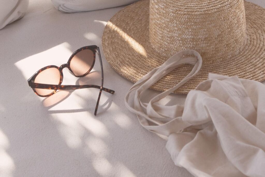 sunglasses and sun hat on with pink aesthetic