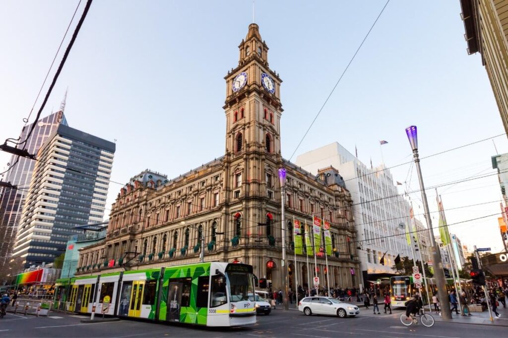 melbourne flinders street station with green tram 