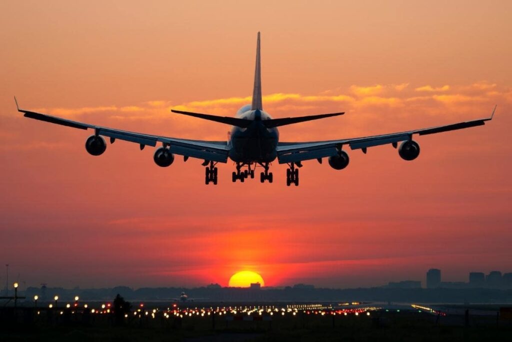 plane landing with red sunset